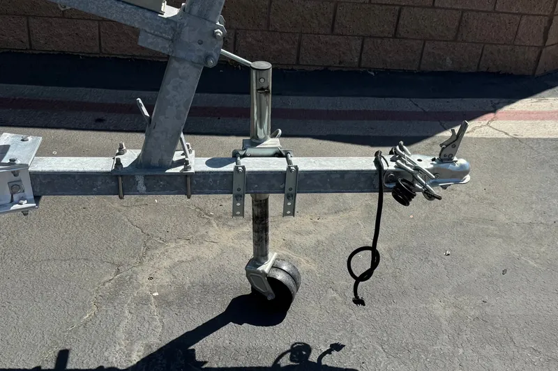Slide: The Image of Trailer hitch of a 2024 NauticStar 211 Hybrid boat on pavement. - 35