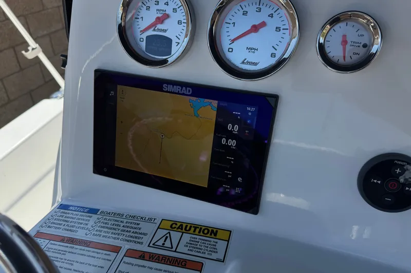 Slide: The Image of Dashboard of 2024 NauticStar 211 Hybrid boat with Simrad display and gauges. - 29