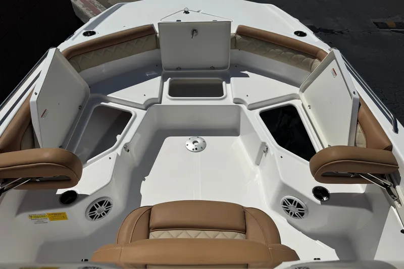 Slide: The Image of 2024 NauticStar 211 Hybrid boat interior with tan seating and storage compartments. - 13