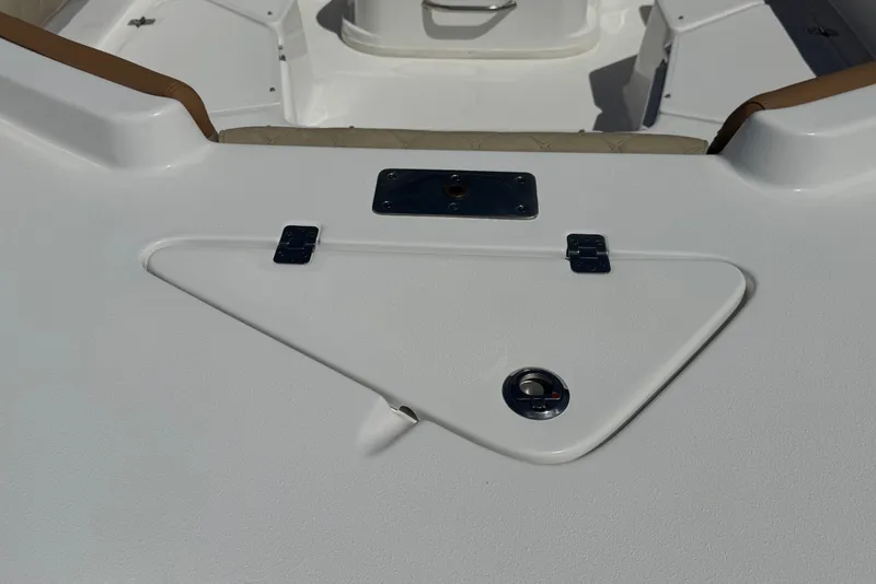 Slide: The Image of 2024 NauticStar 211 Hybrid boat deck with storage compartment and seating area. - 9