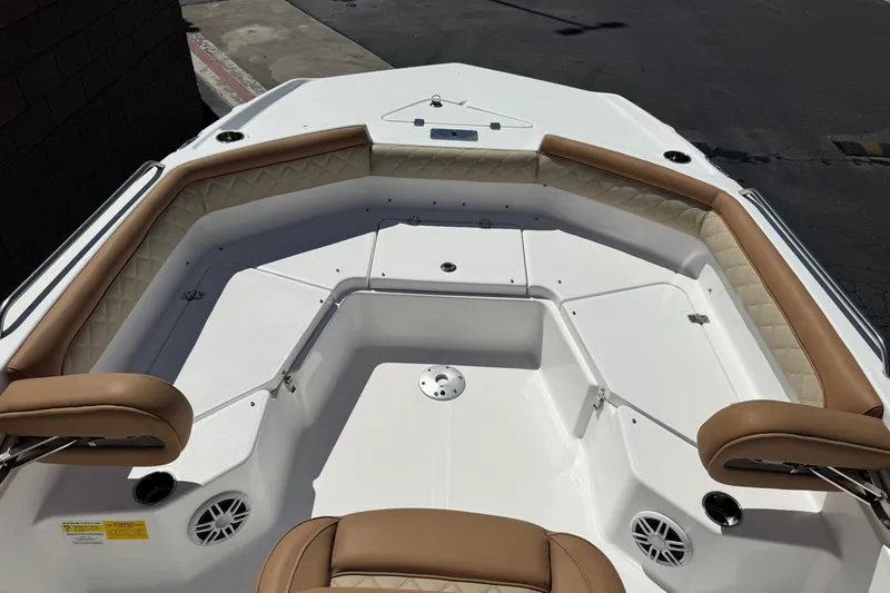 Slide: The Image of 2024 NauticStar 211 Hybrid boat interior with tan seating and white deck. - 12