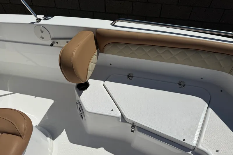 Slide: The Image of 2024 NauticStar 211 Hybrid boat interior with tan seating and storage compartment. - 14