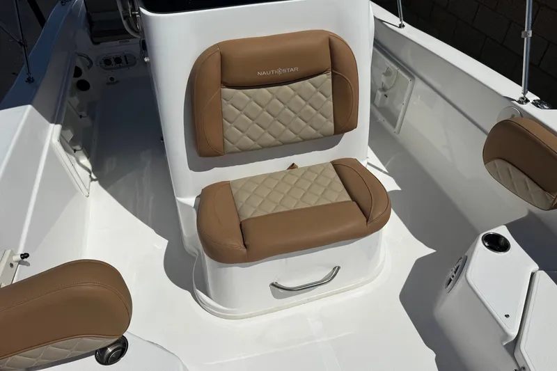 Slide: The Image of 2024 NauticStar 211 Hybrid boat interior with tan quilted seating. - 16
