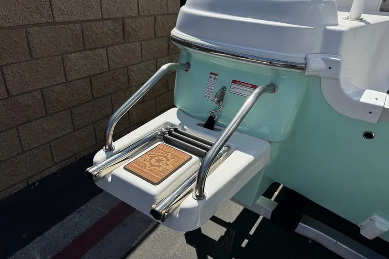 Slide: The Image of 2024 NauticStar 211 Hybrid boat ladder with stainless steel rails and teak step. - 8