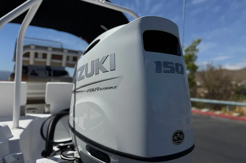 Slide: The Image of 2024 NauticStar 211 Hybrid boat with Suzuki 150 four-stroke engine, outdoor view. - 7