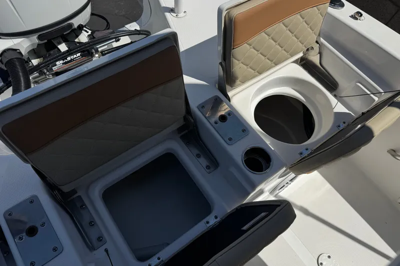Slide: The Image of 2024 NauticStar 211 Hybrid boat interior with open storage compartments and seating. - 23