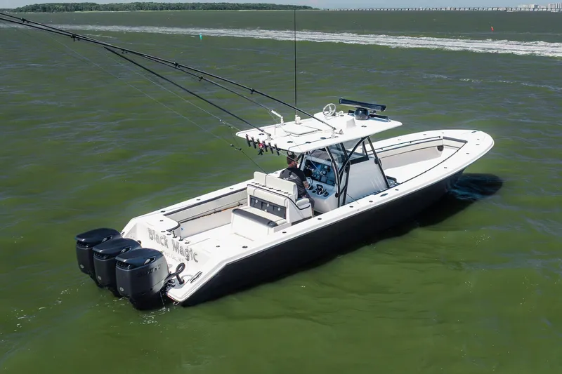 The Image of 2015 SeaHunter 37 Tournament boat with triple engines cruising on open water. - 3