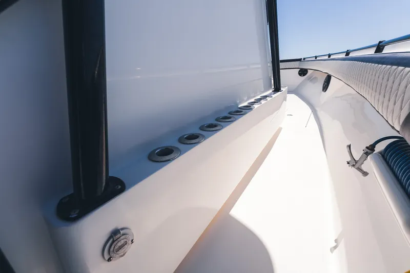 Slide: The Image of 2015 SeaHunter 37 Tournament boat interior with rod holders and cushioned seating. - 20