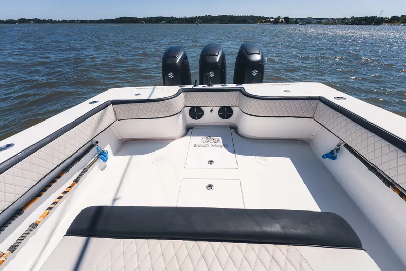 Slide: The Image of 2015 SeaHunter 37 Tournament boat with triple engines on calm water. - 15