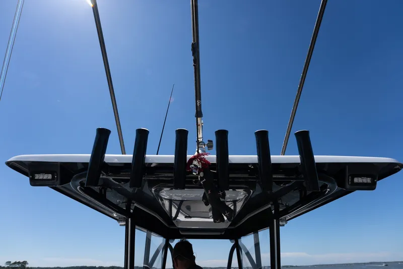 Slide: The Image of 2015 SeaHunter 37 Tournament boat with fishing rod holders under clear blue sky. - 23