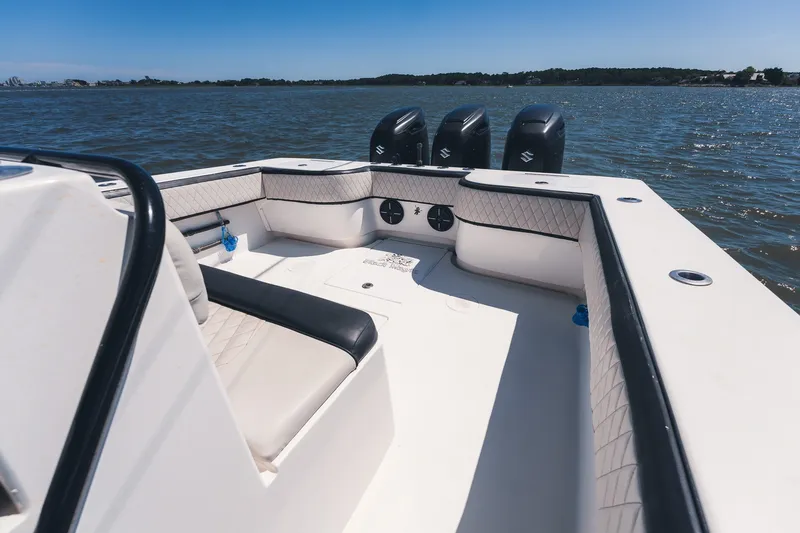 Slide: The Image of 2015 SeaHunter 37 Tournament boat interior with triple outboard motors on a sunny day. - 16