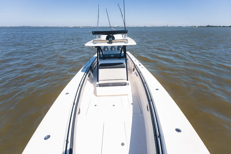 Slide: The Image of 2015 SeaHunter 37 Tournament boat on open water, showcasing sleek design and fishing rods. - 13