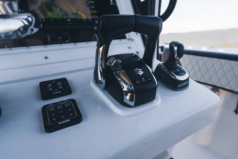 Slide: The Image of Control panel of a 2015 SeaHunter 37 Tournament boat with Suzuki throttle and joystick. - 36