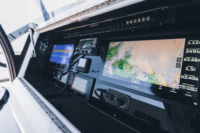 Slide: The Image of Control panel of a 2015 SeaHunter 37 Tournament boat with advanced navigation displays. - 38