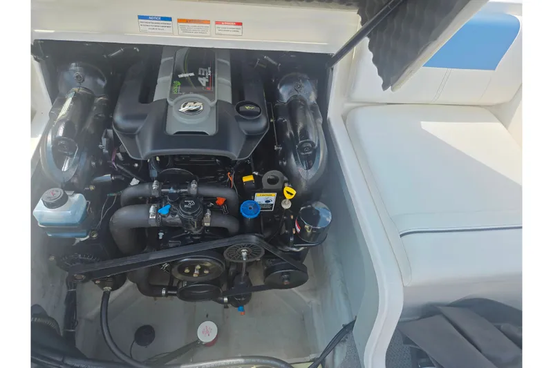 Slide: The Image of Engine compartment of a 2013 Bayliner 195 Bowrider boat, showcasing detailed components. - 22