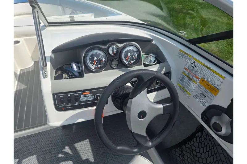 Slide: The Image of 2013 Bayliner 195 Bowrider dashboard with steering wheel and instrument panel. - 14