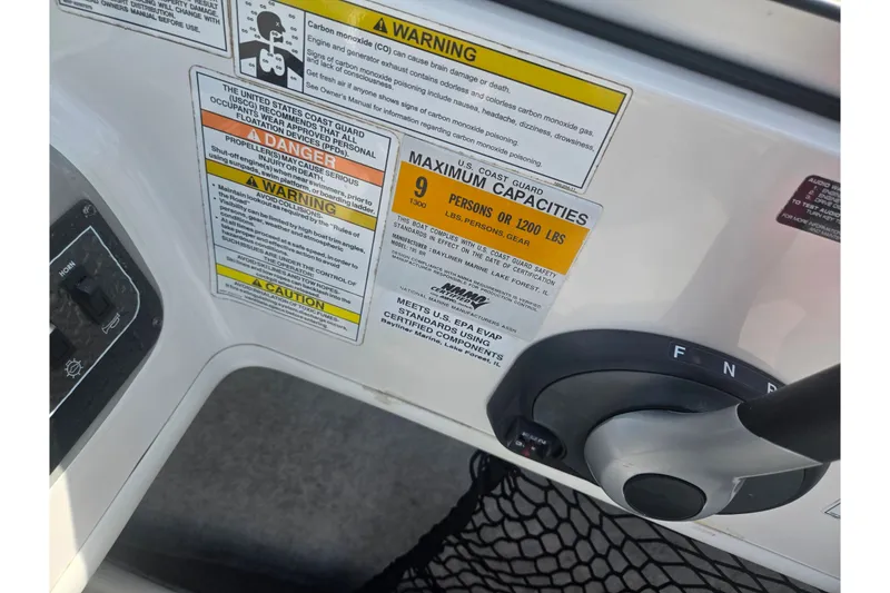 Slide: The Image of Control panel of a 2013 Bayliner 195 Bowrider with safety and capacity warnings. - 15