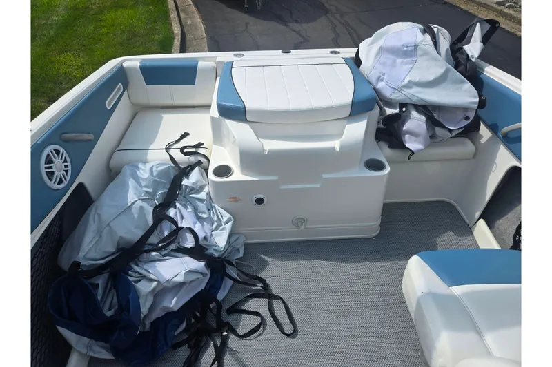 Slide: The Image of 2013 Bayliner 195 Bowrider interior with blue and white seating, storage, and gear. - 20