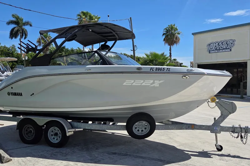 Slide: The Image of 2023 Yamaha Boats 222XD on trailer, parked at Tuppen's South Location, sunny day. - 3