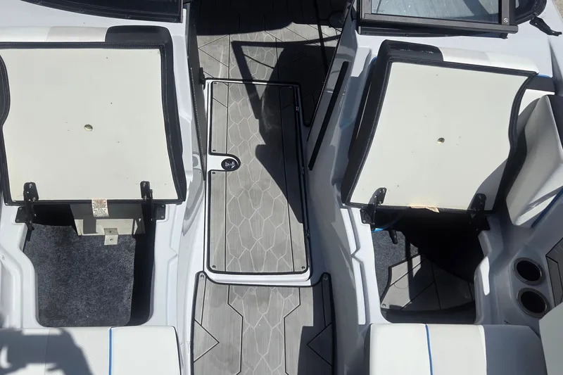 Slide: The Image of 2023 Yamaha Boats 222XD interior with open storage compartments and sleek flooring design. - 20