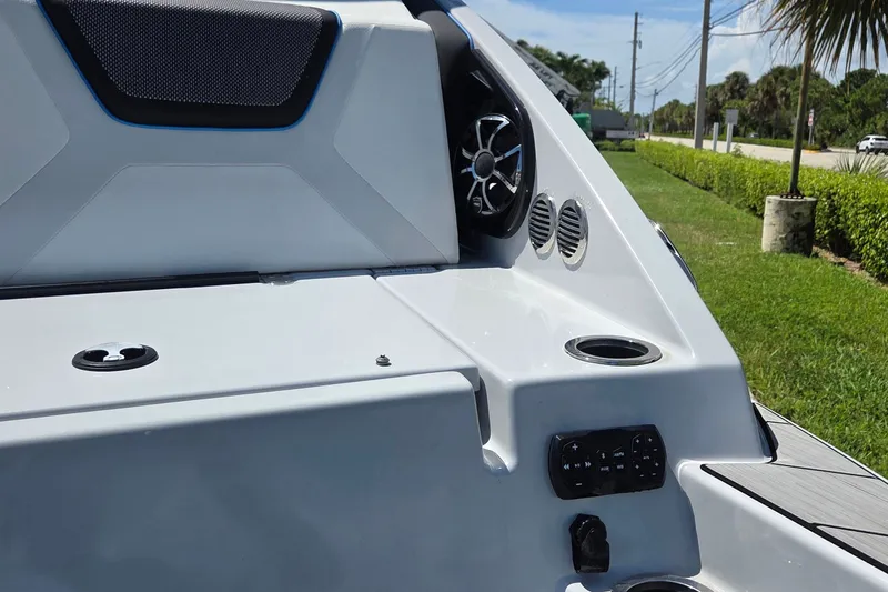 Slide: The Image of 2023 Yamaha Boats 222XD interior with speaker, cup holders, and control panel. - 26