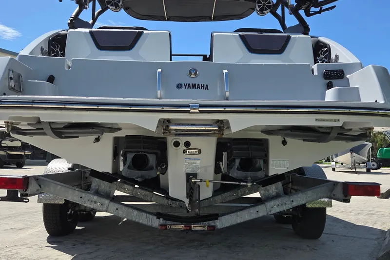 Slide: The Image of Rear view of 2023 Yamaha Boats 222XD on a trailer, showcasing dual engines. - 5