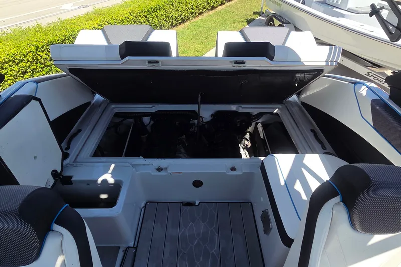 Slide: The Image of 2023 Yamaha Boats 222XD engine compartment with open hatch, showcasing interior design. - 11
