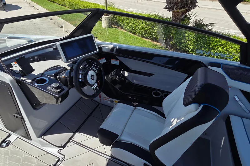 Slide: The Image of 2023 Yamaha Boats 222XD cockpit with modern steering and touchscreen display. - 23