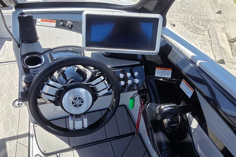 Slide: The Image of 2023 Yamaha Boats 222XD dashboard with steering wheel and touchscreen display. - 8