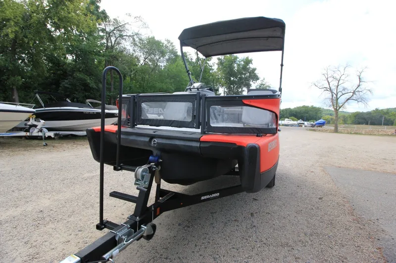Slide: The Image of 2022 Sea-Doo Switch Sport 18 on trailer, parked outdoors with trees in background. - 4