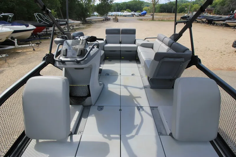 Slide: The Image of 2022 Sea-Doo Switch Sport 18 pontoon boat interior with seating and steering console. - 6