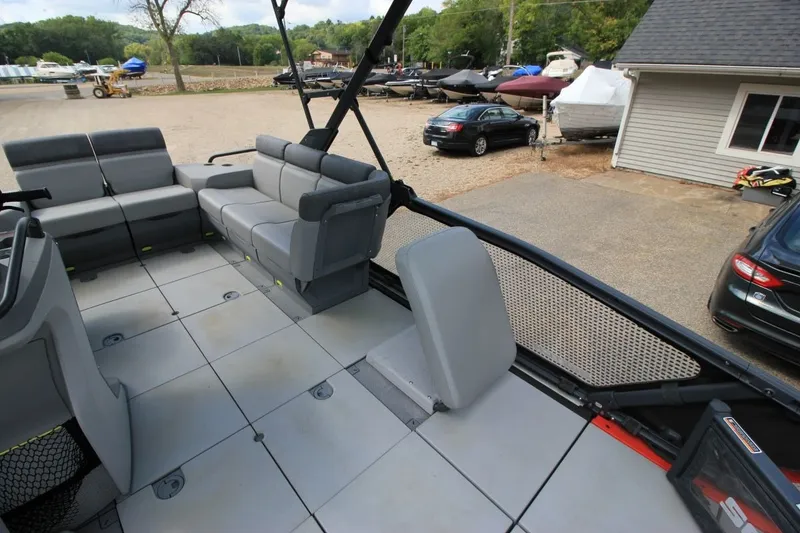 Slide: The Image of 2022 Sea-Doo Switch Sport 18 interior with gray seating and spacious deck layout. - 12