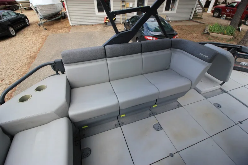 Slide: The Image of 2022 Sea-Doo Switch Sport 18 interior with gray seating and cup holders. - 9