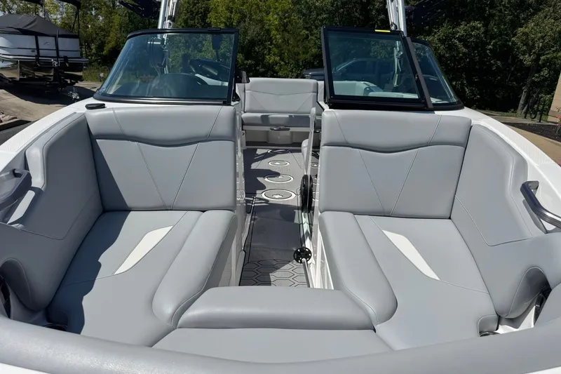 Slide: The Image of 2022 MasterCraft NXT22 boat interior with gray seating and open windshield. - 7