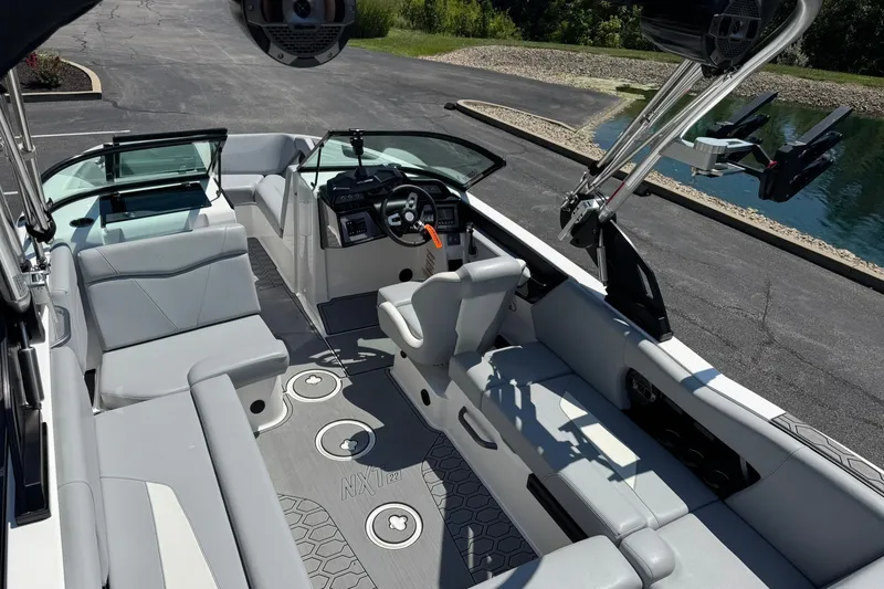 Slide: The Image of 2022 MasterCraft NXT22 boat interior with sleek seating and modern dashboard. - 14