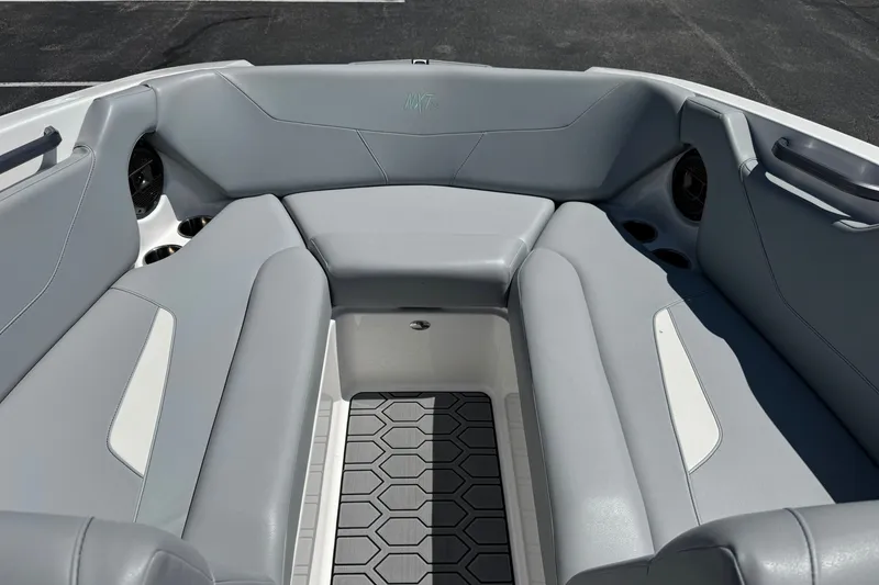 Slide: The Image of 2022 MasterCraft NXT22 boat interior with gray seating and cup holders. - 8
