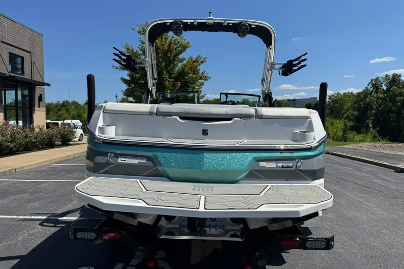 Slide: The Image of 2022 MasterCraft NXT22 boat in parking lot, rear view, sunny day. - 4