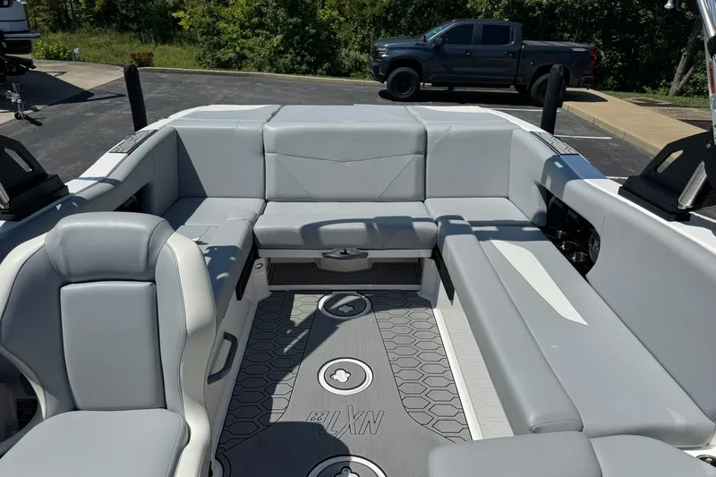 Slide: The Image of 2022 MasterCraft NXT22 boat interior with gray seating and modern design. - 11