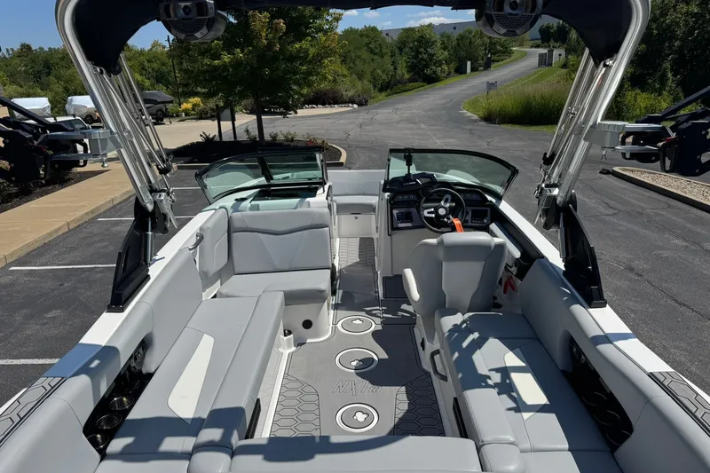 Slide: The Image of 2022 MasterCraft NXT22 boat interior with sleek seating and modern dashboard. - 13