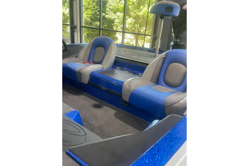 Slide: The Image of 2021 Ranger Z518 boat interior with blue and gray seating, showcasing modern design. - 7