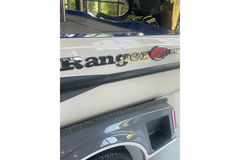 Slide: The Image of 2021 Ranger Z518 boat, close-up of logo and sleek design details. - 2