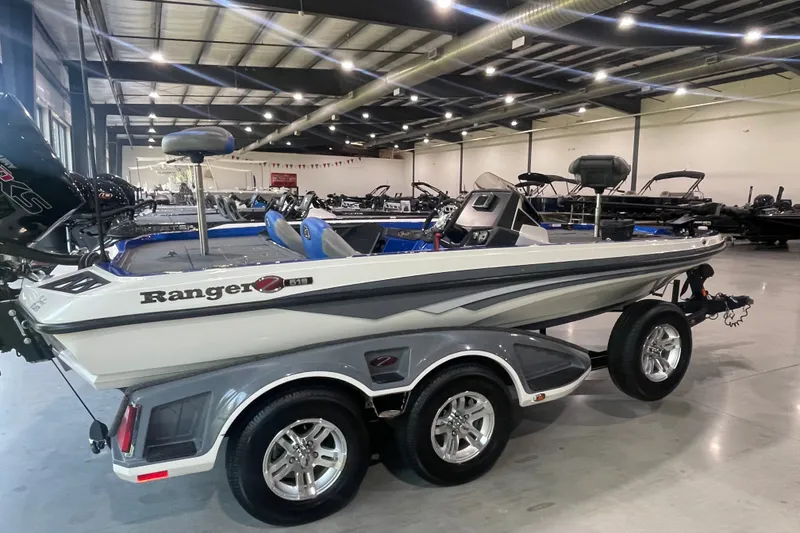 Slide: The Image of 2021 Ranger Z518 boat in showroom, side view with trailer, under bright lighting. - 3