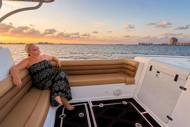 Slide: The Image of Woman relaxing on a 2006 Donzi 38 ZFX Cuddy boat at sunset. - 36