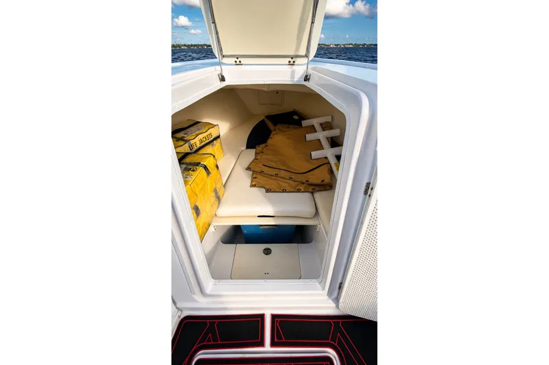 Slide: The Image of 2006 Donzi 38 ZFX Cuddy cabin interior with life jackets and storage space. - 35