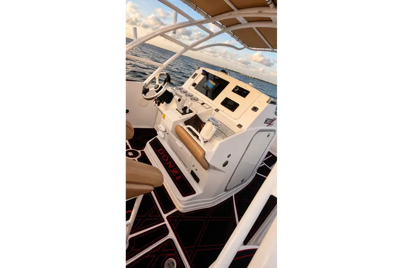 Slide: The Image of 2006 Donzi 38 ZFX Cuddy boat cockpit with steering wheel and controls, ocean view. - 39