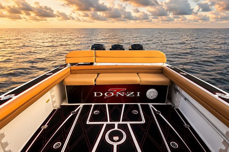 Slide: The Image of 2006 Donzi 38 ZFX Cuddy boat interior with sunset ocean view. - 26