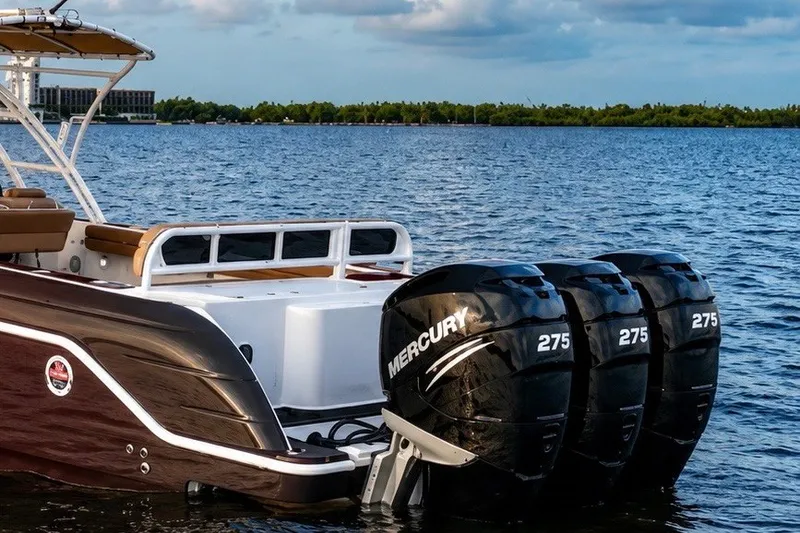 Slide: The Image of 2006 Donzi 38 ZFX Cuddy boat with triple Mercury 275 engines on a calm lake. - 19