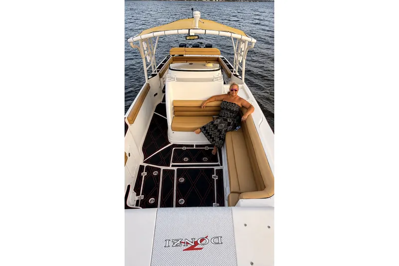 Slide: The Image of 2006 Donzi 38 ZFX Cuddy boat with a person relaxing on deck. - 37
