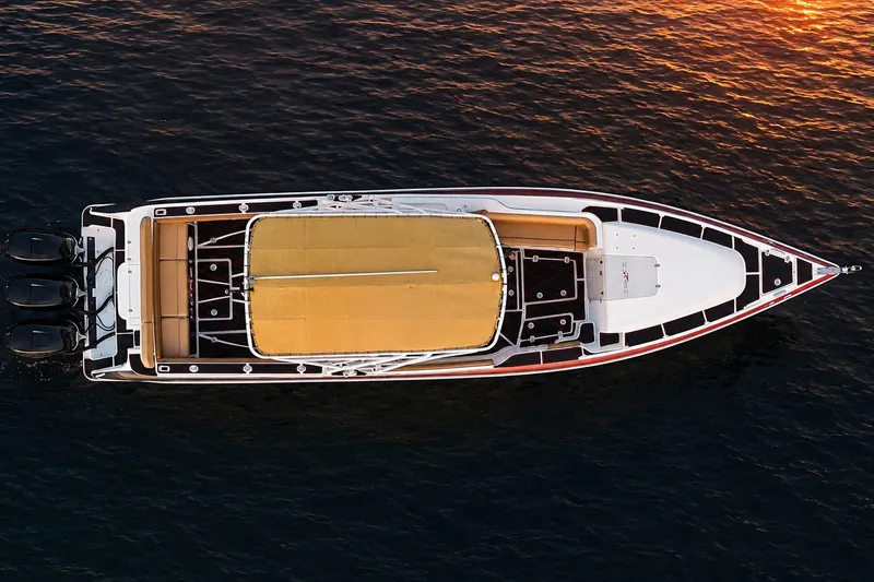 Slide: The Image of Overhead view of a 2006 Donzi 38 ZFX Cuddy boat on water at sunset. - 14