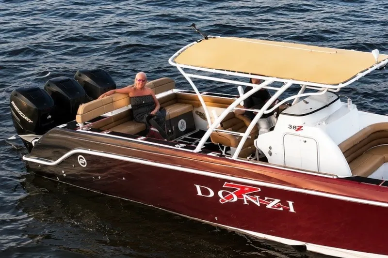Slide: The Image of 2006 Donzi 38 ZFX Cuddy boat on water, featuring sleek design and powerful engines. - 27